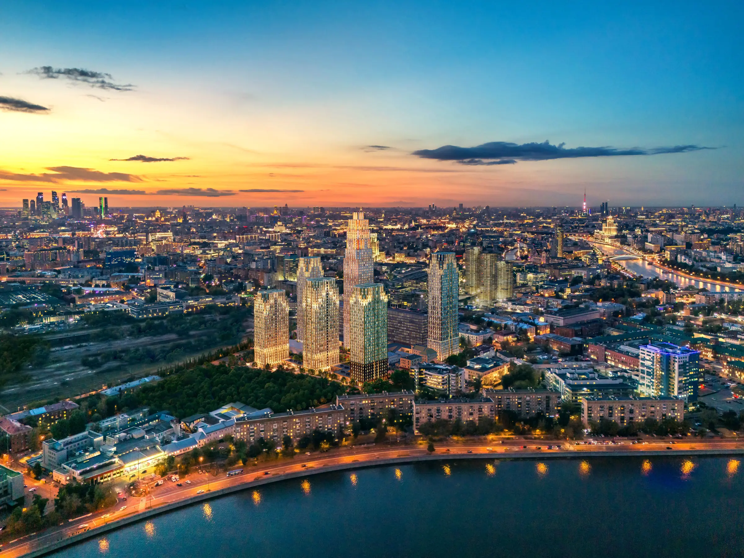 Dusk aerial of residential towers by the river